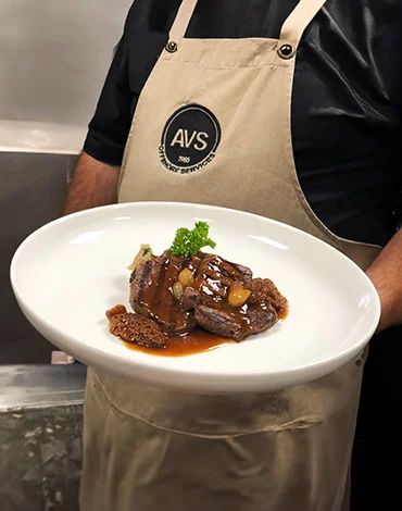 AVS chef serving his wonderful meat dish